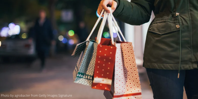 A woman holding some bags with her Christmas shopping