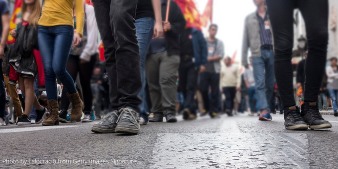 The legs of people demonstrating in a street