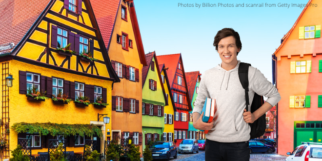 A young man with his rucksack and some books standing in a small town in Germany