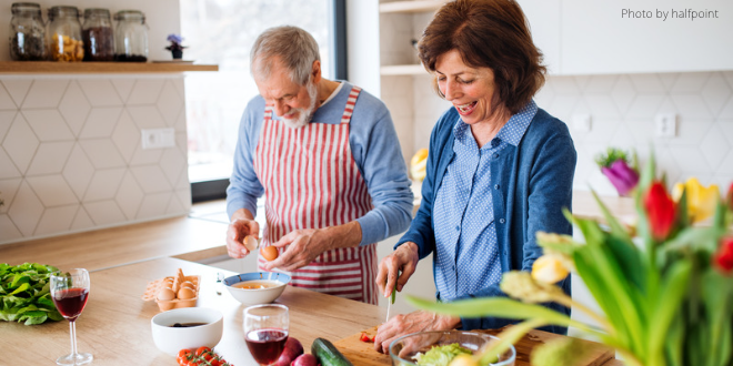 Two people working in the kitchen together and preparing a meal