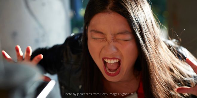 A young woman screaming in anger