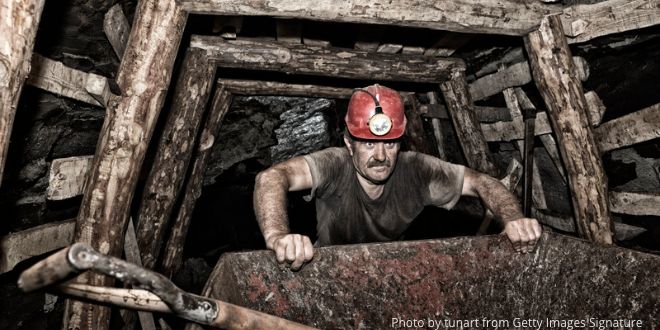 A coal miner working in a coal mine