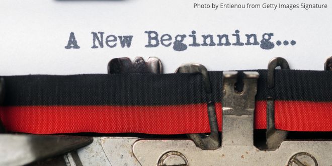 A close-up of an old typewriter typing the words "A new beginning"