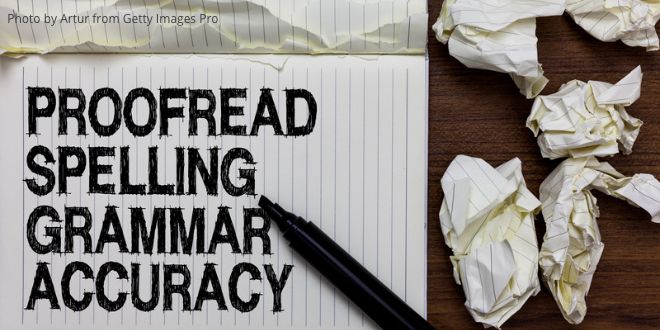 A piece of paper with the following handwritten words: Proofread, Spelling, Grammar, Accuracy—and screwed up pieces of paper next to it.