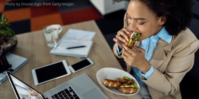 A business woman eating during an online video call