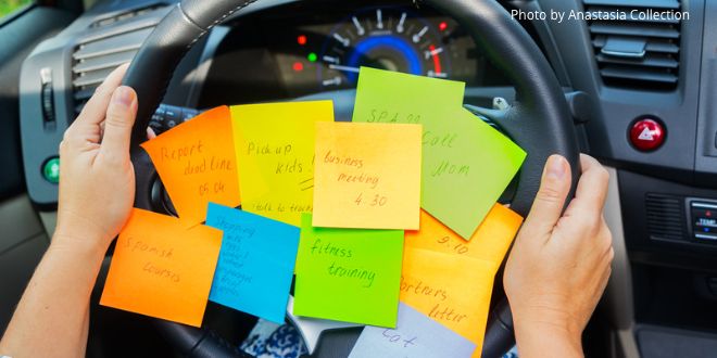 Different-coloured post-it notes stuck on a car's steering wheel