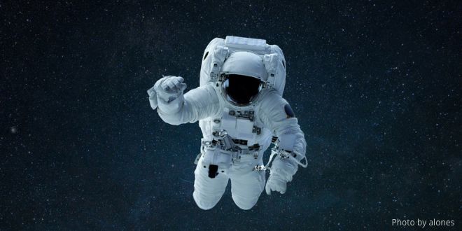 An astronaut flying in outer space