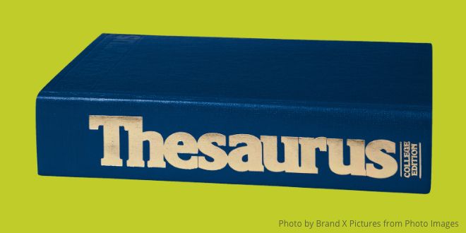 A blue Thesaurus on a green background