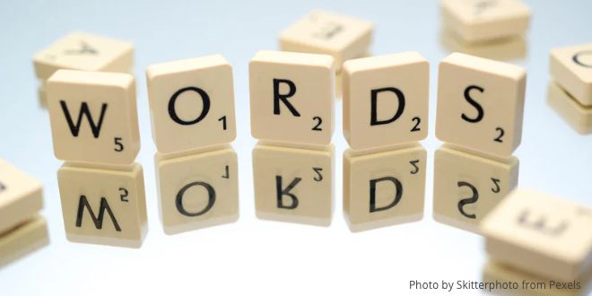 Scrabble tiles showing the word "Words", standing on a mirror