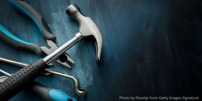 A hammer nd other tools on a blue background