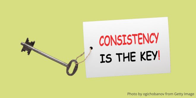 A key with a label fixed to it and the words: Consistency is the key