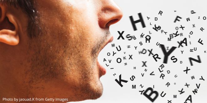 The side of a man's face with lots of letters coming out of his mouth