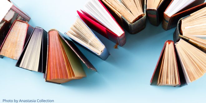 Books lined up in a curve on a blue background