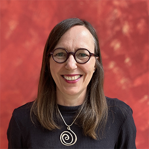 Lisa Blum in front of a red background