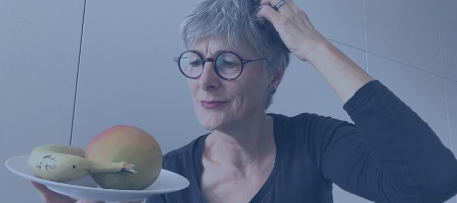 5 strategies A photo of me - Christine Burgmer - looking at a place of fruits in a puzzled way.