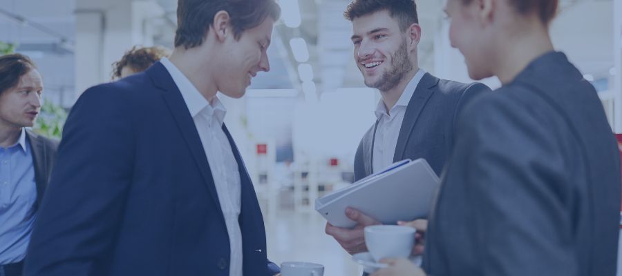 Three people talking to each other in the office