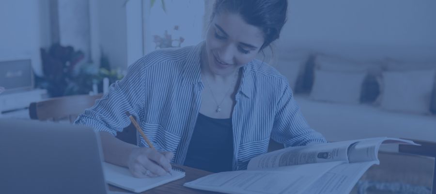 A woman sitting at her desk writing