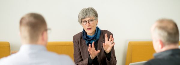Christine Burgmer in a company meeting room with two clients.
