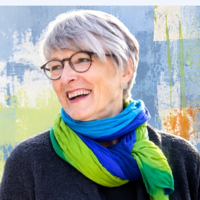 Christine Burgmer, smiling, on a colourful background